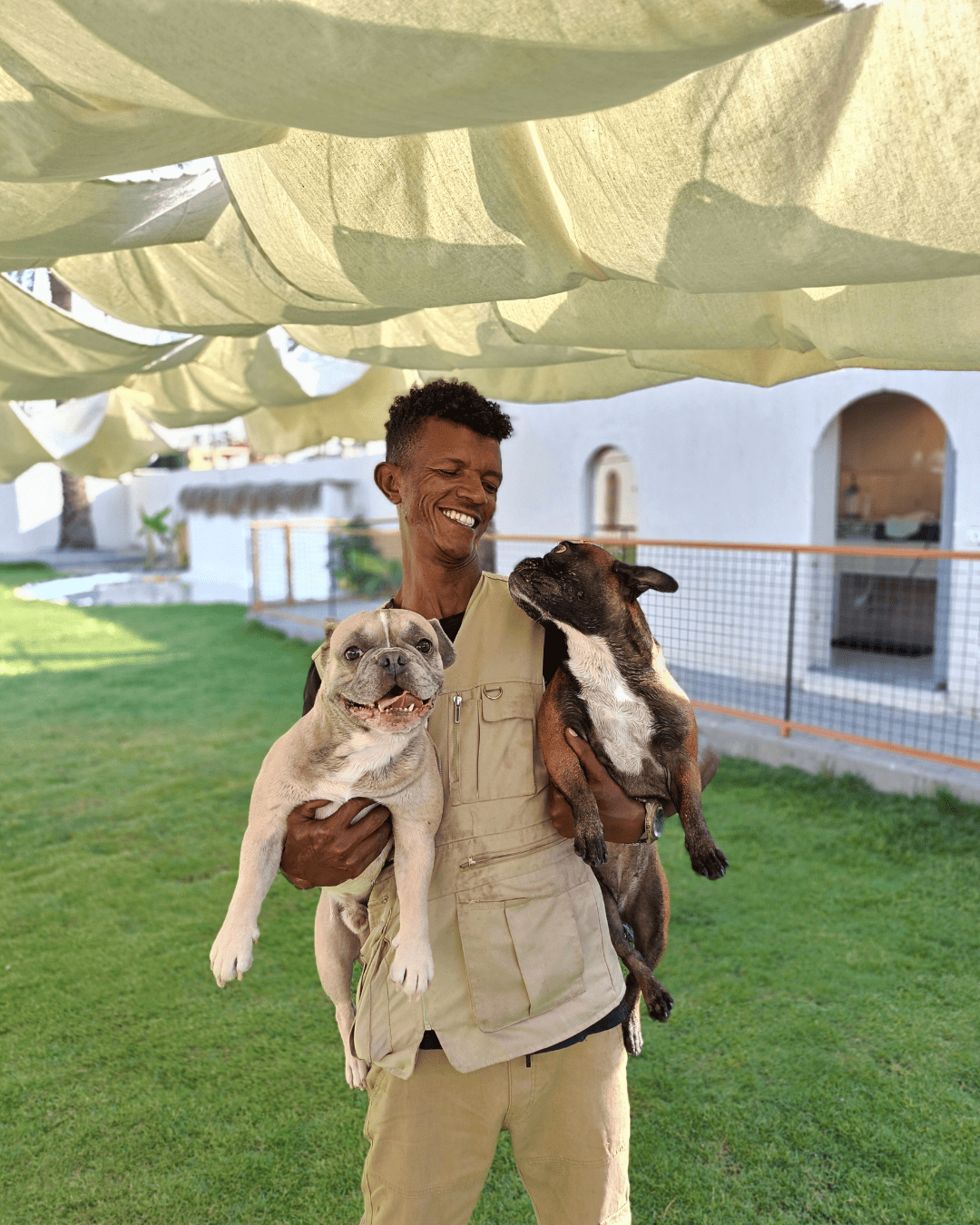 Dog Keeper caring 2 french bulldogs in the park (1).png